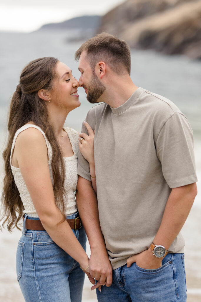 Couple about to kiss with cliffs in the background