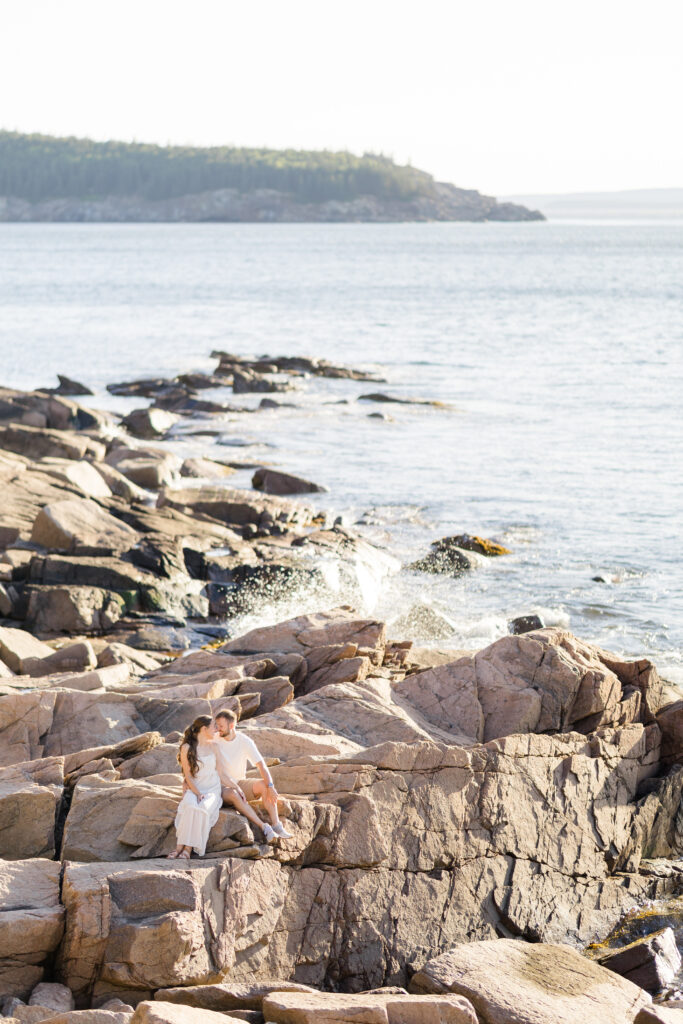 Coastal Engagement Session with water splashing on the rocks